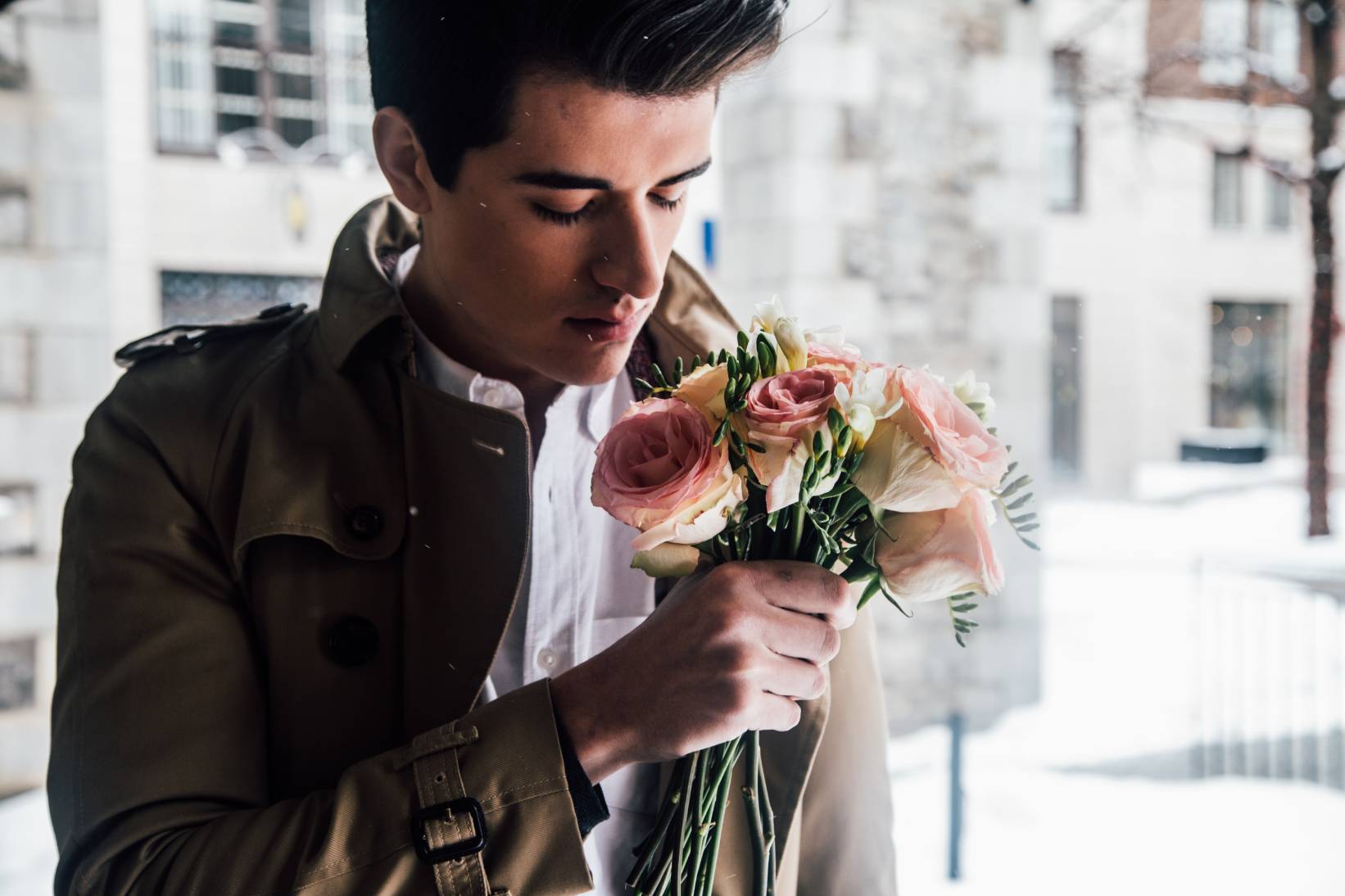 A man holding a bouquet of flowers